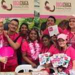Eight people in pink T-shirts from the Oogacha LGBTQ+ organization in Singapore.
