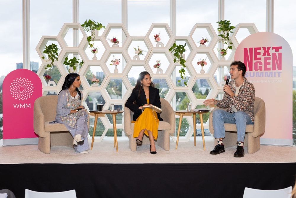 Article Banner - Three young climate leaders, seated, talking on a stage for a panel.