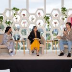 Article Banner - Three young climate leaders, seated, talking on a stage for a panel.