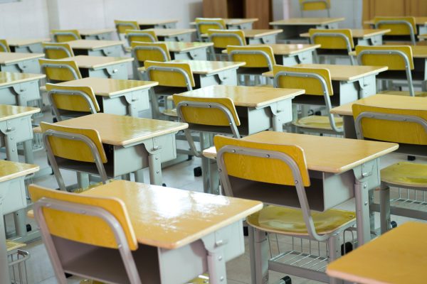Desks in an empty school classroom.