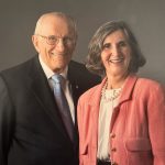 Article Banner - Stan Pauley, in a dark suit, stands beside Dorothy Pauley, in a salmon coat
