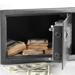 Article Banner - Safe with door open and money inside, with some bills outside.