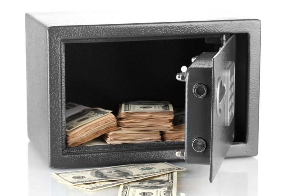 Article Banner - Safe with door open and money inside, with some bills outside.